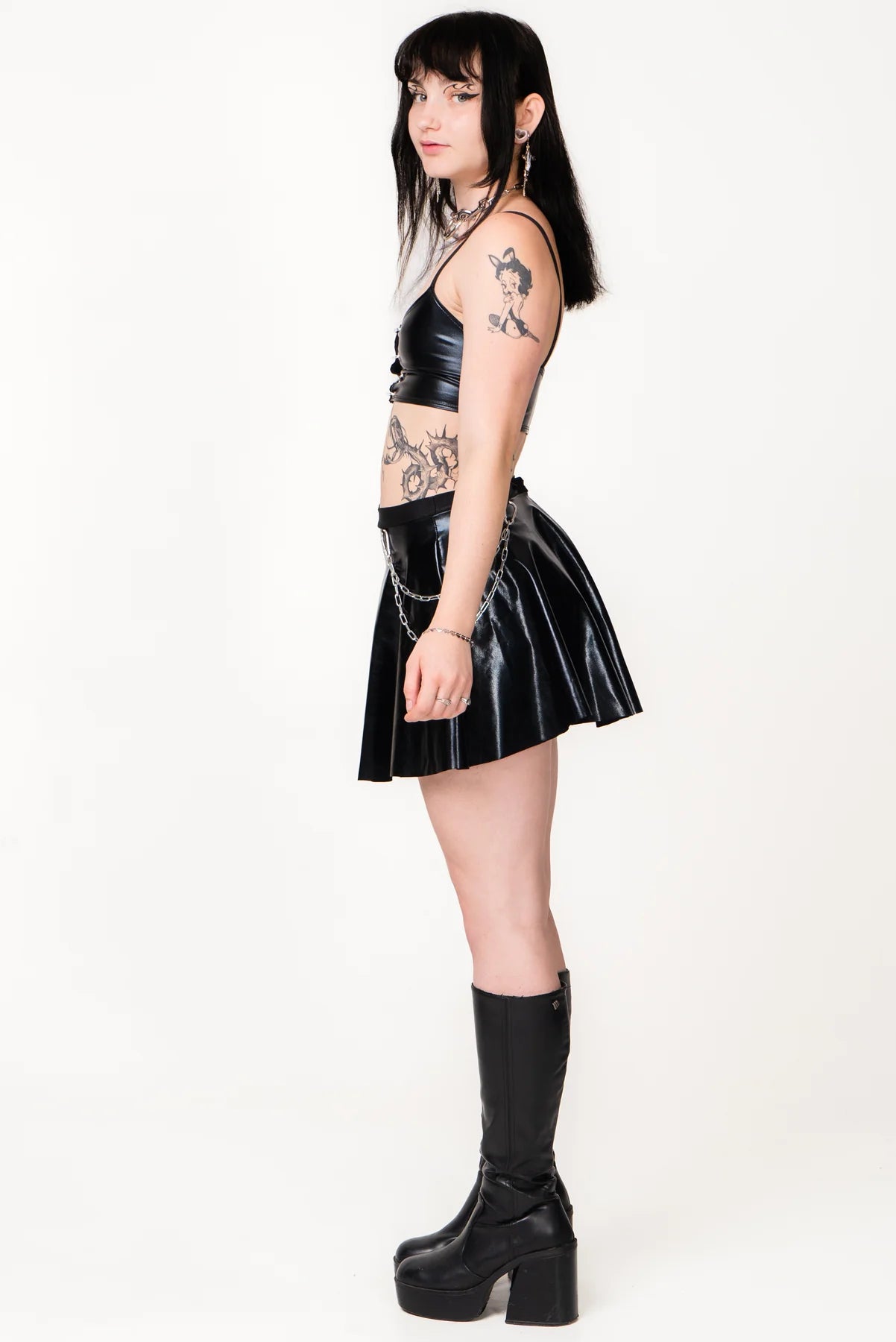 zijkant meisje met zwarte vinyl outfit aan